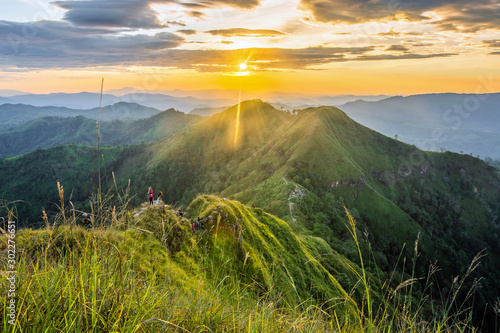 Group of tourists climbing up the mountain top with a blue sky background in Thongphaphum National Park, ,Khao Chang Phueak, Thailand.