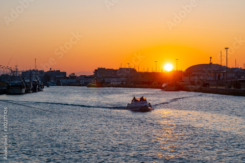 Little boat for fishing in Fiumicino port at sunrise. photo