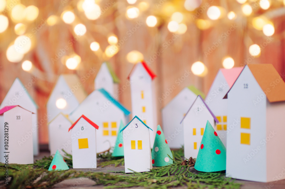 Christmas advent calendar of paper houses with garland lights