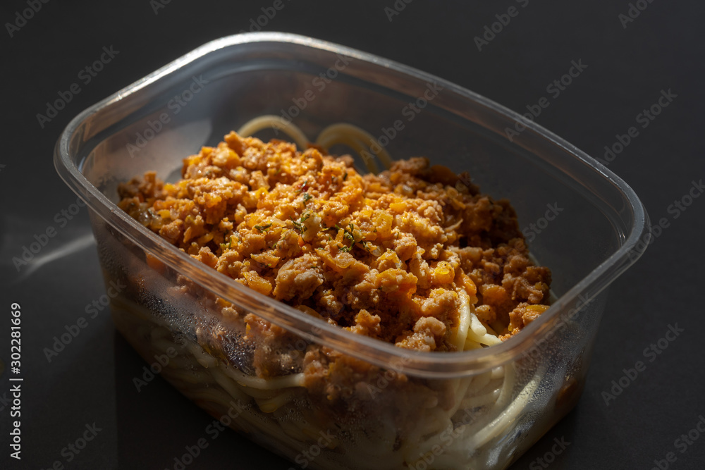 Pasta with minced meat and onion in navy-style on a gray background. Pasta with minced meat and onion in navy-style on a gray background.