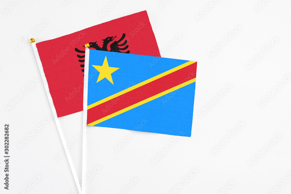 Congo and Albania stick flags on white background. High quality fabric, miniature national flag. Peaceful global concept.White floor for copy space. Congo and Albania stick flags on white background. High quality fabric, miniature national flag. Peaceful global concept.White floor for copy space.