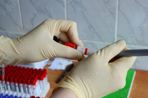 Medical tests. The nurse conducts analytical blood tests in the treatment room at the hospital. Season of viruses, vaccinations. photo