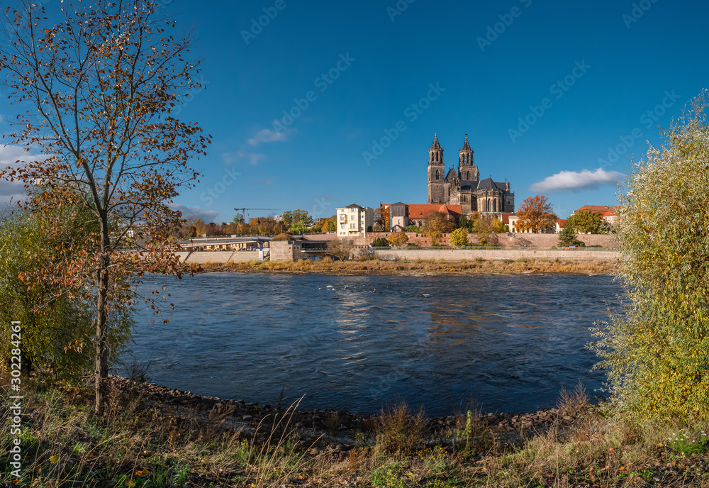 Panoramic view of Magnificent Cathedral, Elbe river in golden Autumn colors at downtown of Magdeburg, city center, Magdeburg, Germany