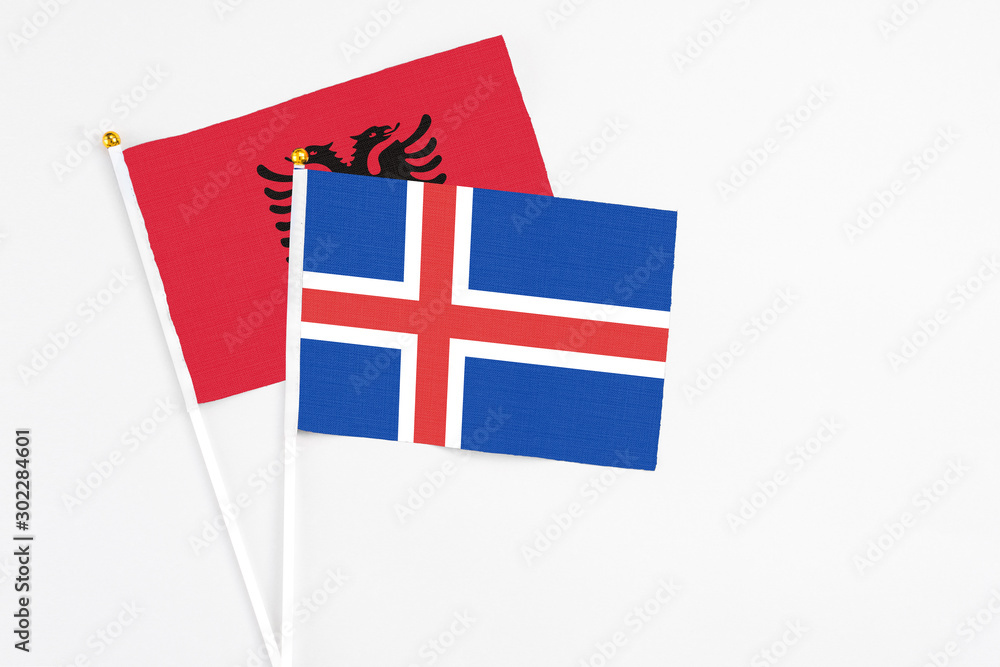 Iceland and Albania stick flags on white background. High quality fabric, miniature national flag. Peaceful global concept.White floor for copy space. Iceland and Albania stick flags on white background. High quality fabric, miniature national flag. Peaceful global concept.White floor for copy space.