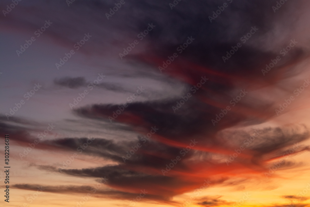 dramatic sky with Spiral clouds.  Reds and oranges fill the picture