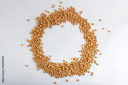 Dried chickpeas in the shape of a round frame on a white background