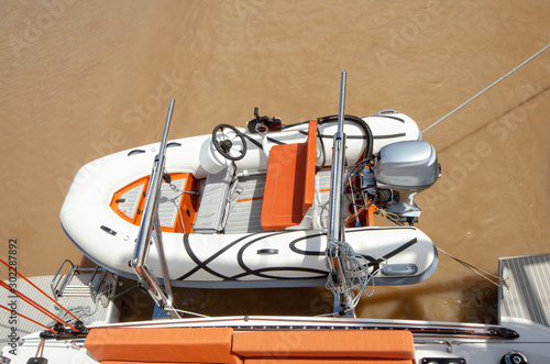 Dinghy on davit on a back of a catamaran cruising on the Garonne river photo