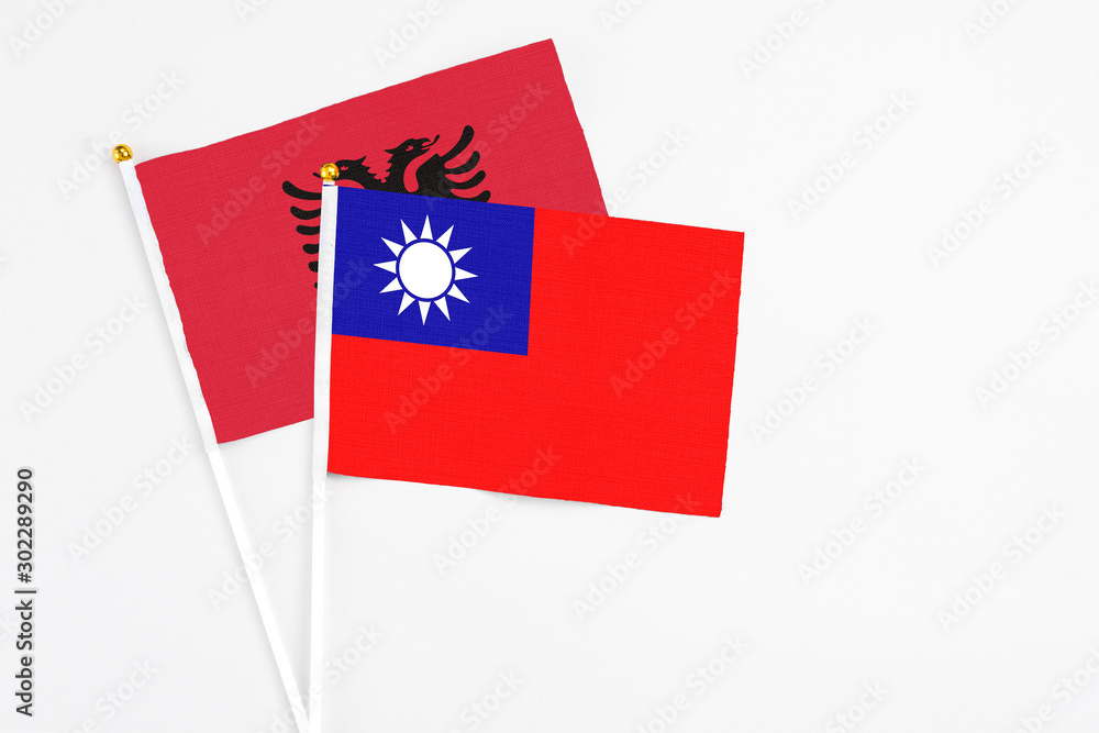 Taiwan and Albania stick flags on white background. High quality fabric, miniature national flag. Peaceful global concept.White floor for copy space. Taiwan and Albania stick flags on white background. High quality fabric, miniature national flag. Peaceful global concept.White floor for copy space.