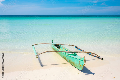 Small bangka outrigger boat on beach, Boracay Island, Philippines photo