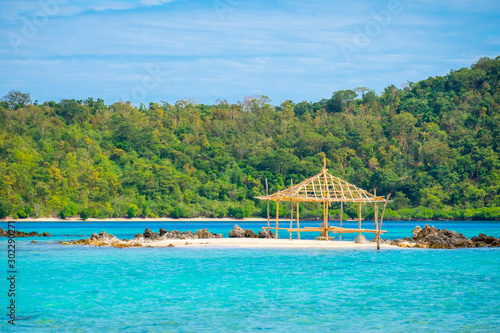 Bamboo structure on beach surrounded by blue water, Coron, Philippines photo