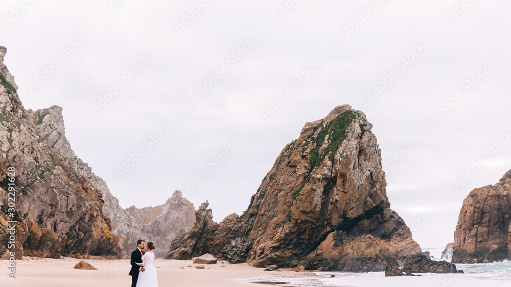 high stone cliffs and sandy coast of the ocean. the bride and gr
