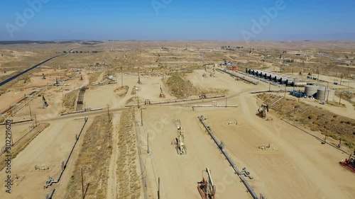 Aerial view Oil Pumpjack. Oil industry equipment. Rig energy machine for petroleum crude. Daylight, morning, blue sky. California. USA