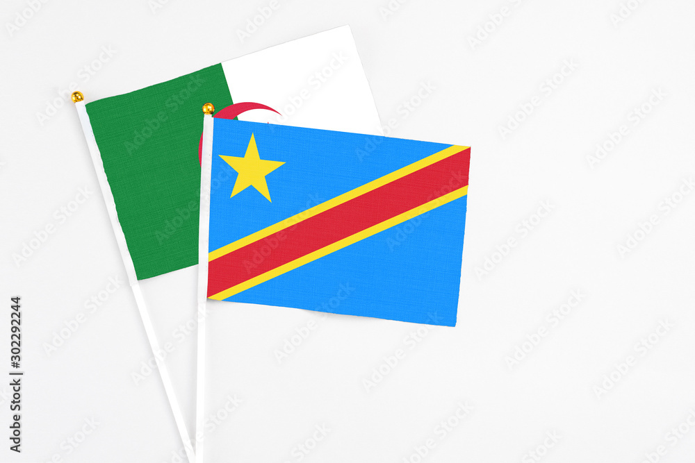 Congo and Algeria stick flags on white background. High quality fabric, miniature national flag. Peaceful global concept.White floor for copy space. Congo and Algeria stick flags on white background. High quality fabric, miniature national flag. Peaceful global concept.White floor for copy space.