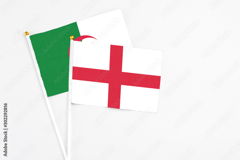 England and Algeria stick flags on white background. High quality fabric, miniature national flag. Peaceful global concept.White floor for copy space.