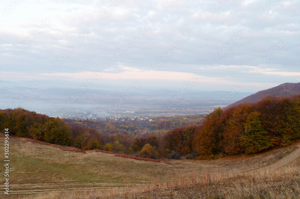 Panoramic view on fog village, Carpathian mountains, Ukraine. Horizontal outdoors shot