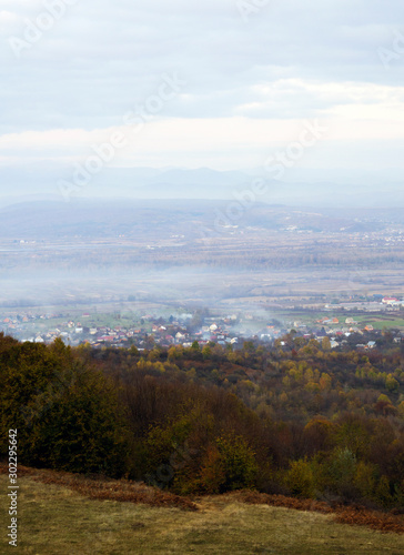 Panoramic view on fog village, Carpathian mountains, Ukraine. Vertical outdoors shot