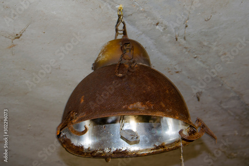 Old, rusty lantern hanging on the ceiling