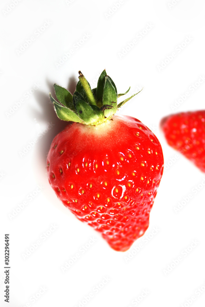 Fresh strawberries isolated on the white plate.