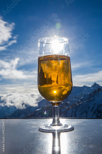 Glass of beer with the Serre Chevalier Alps in the background, France