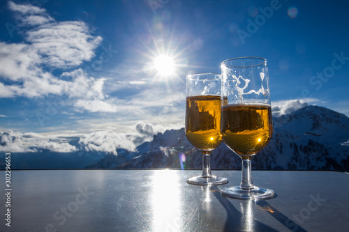 Glass of beer with the Serre Chevalier Alps in the background, France