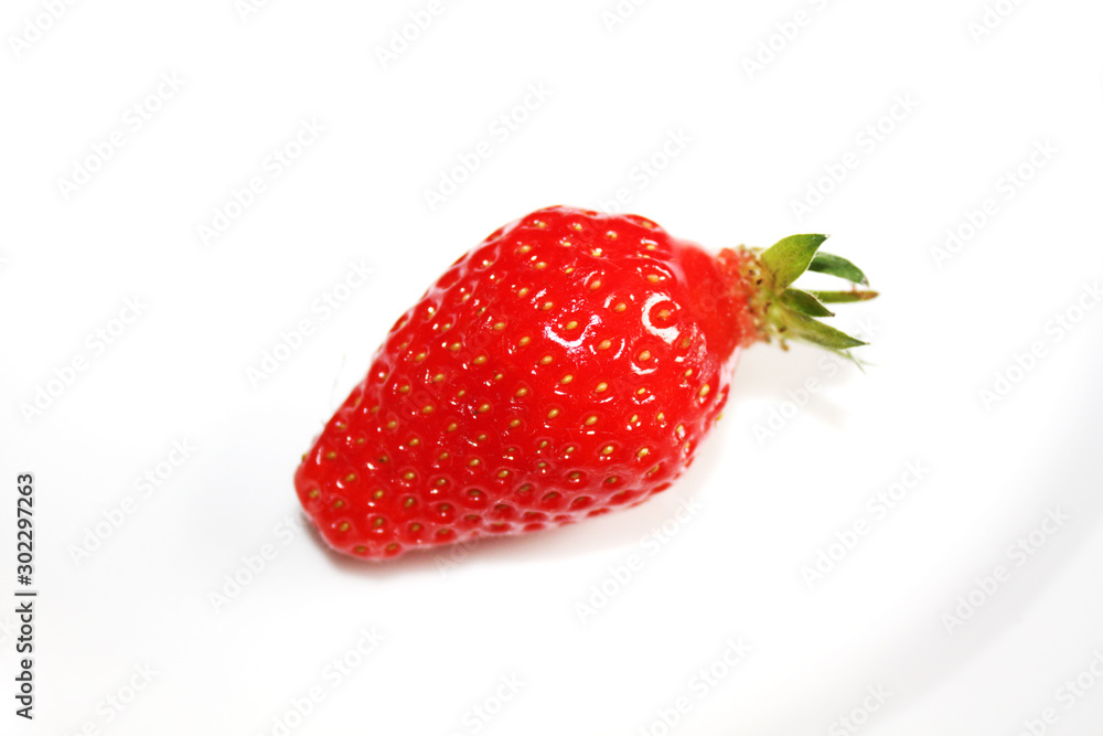 Fresh strawberry isolated on the white plate.