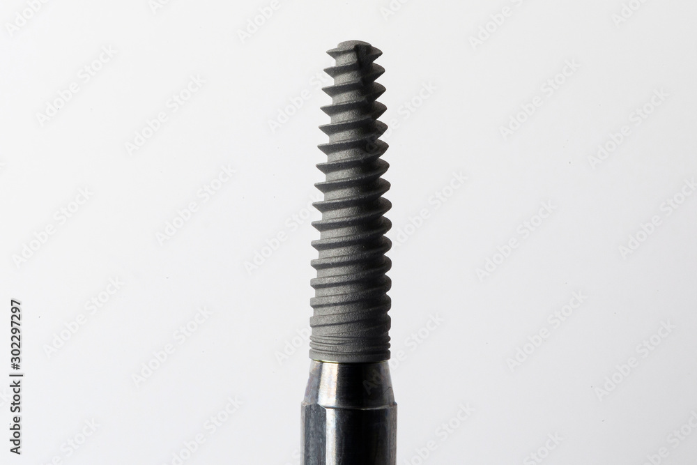 medium-sized dental implant for tooth and root restoration on a white background medium-sized dental implant for tooth and root restoration on a white background