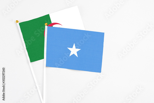 Free Download Somalia and Algeria stick flags on white background. High quality fabric, miniature national flag. Peaceful global concept.White floor for copy space. - GFXLoad