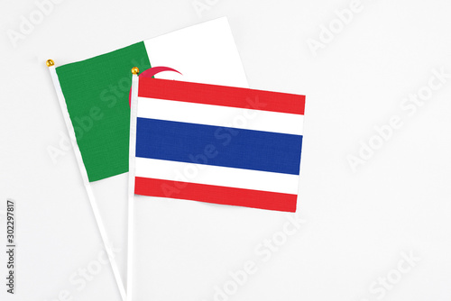 Free Download Thailand and Algeria stick flags on white background. High quality fabric, miniature national flag. Peaceful global concept.White floor for copy space. - GFXLoad