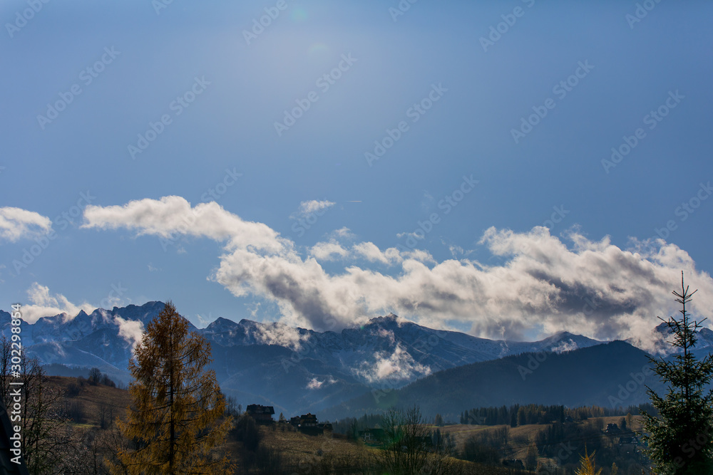 Obraz premium HDR photo of the Tatra Mountains and Great Giewont Peak with the steel Cross between clouds.