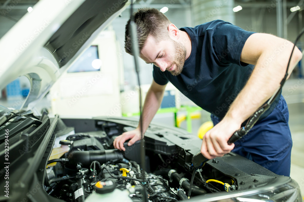 Man working on car in modern factory Man working on car in modern factory