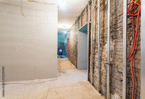 Photos Frames for plasterboard for making gypsum walls on the brick wall in an apartmen