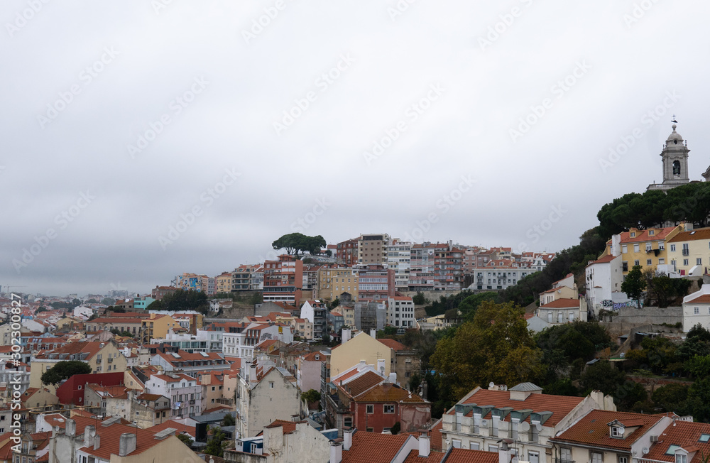 Lisbon rooftops on a cloudy day with church steeple