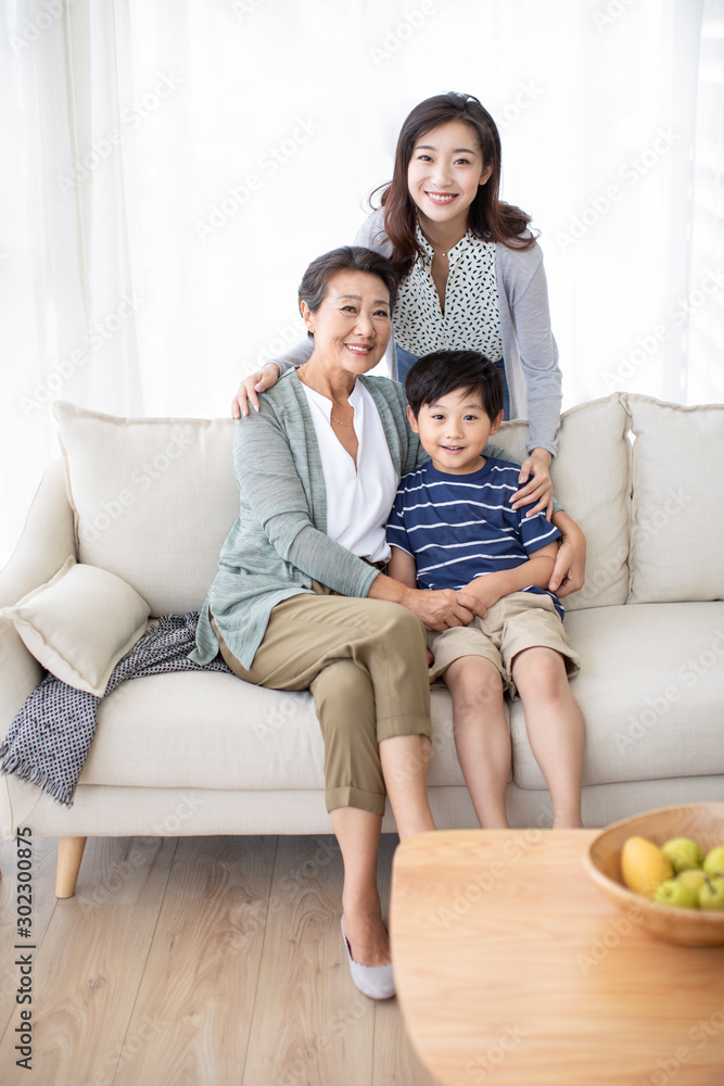 Happy Chinese family relaxing on sofa Happy Chinese family relaxing on sofa