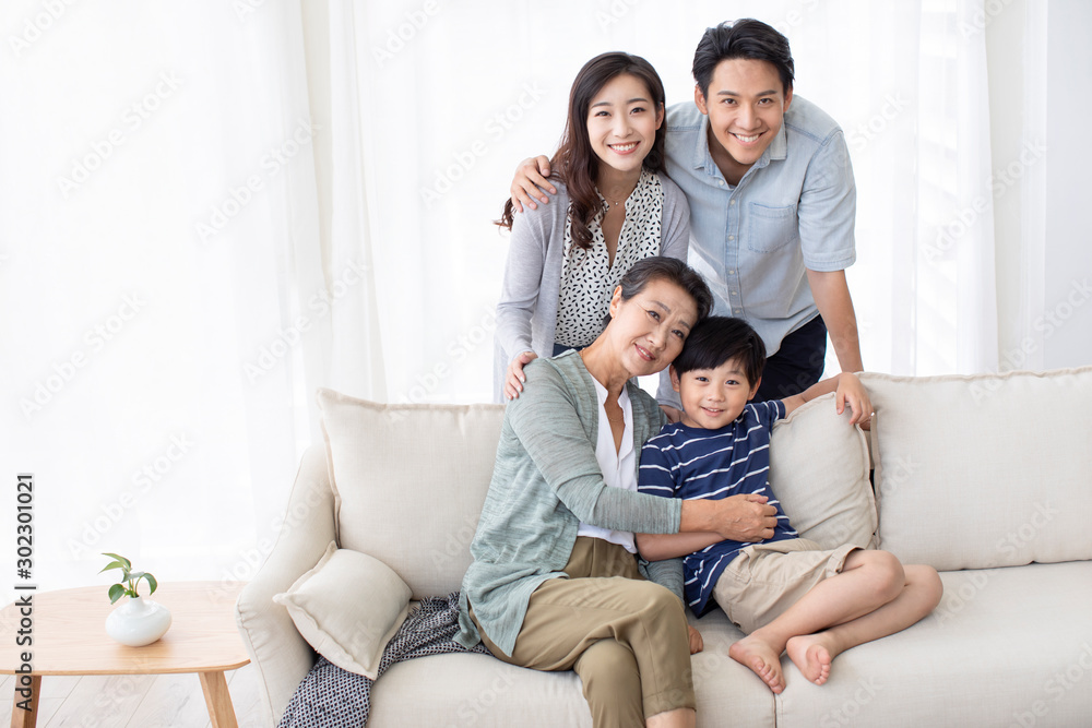 Happy Chinese family relaxing on sofa Happy Chinese family relaxing on sofa