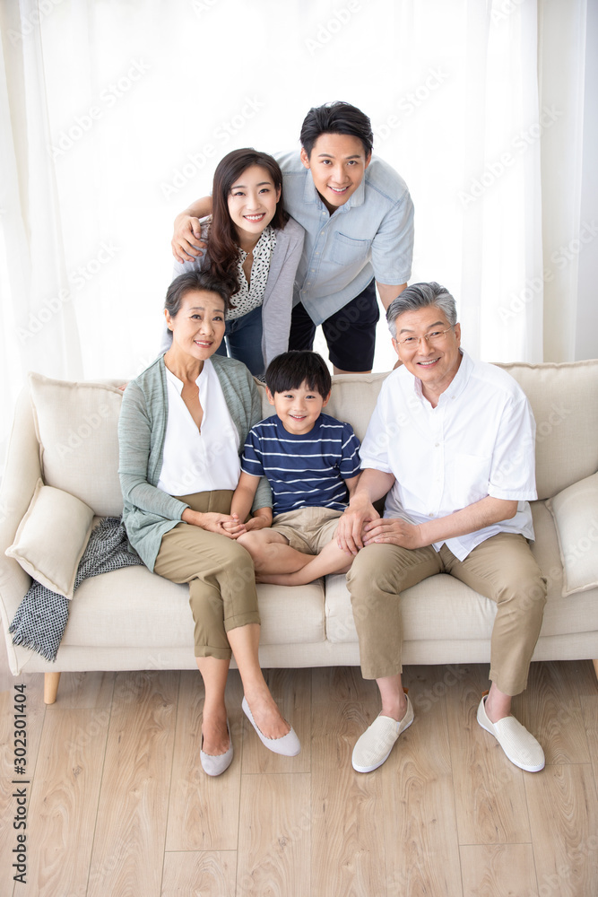 Happy Chinese family relaxing on sofa Happy Chinese family relaxing on sofa