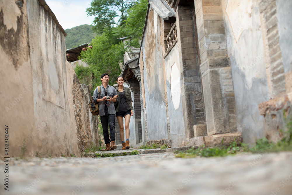 Young Chinese couple walking in village Young Chinese couple walking in village