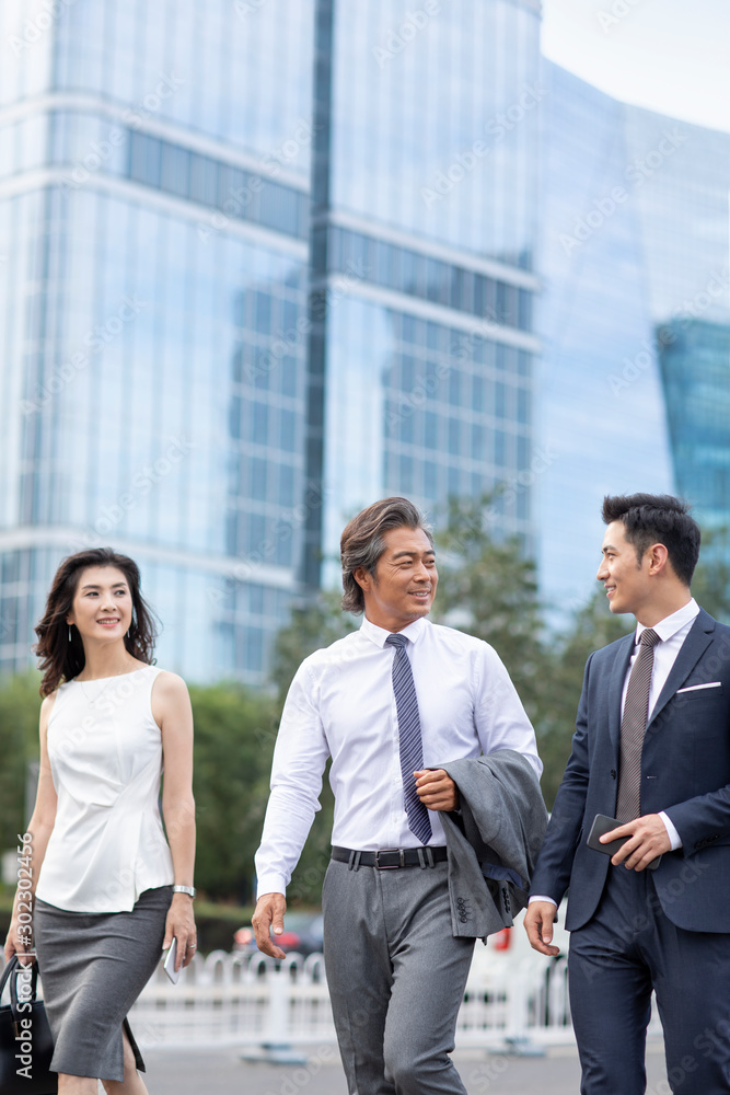 Successful Chinese business people walking on street Successful Chinese business people walking on street