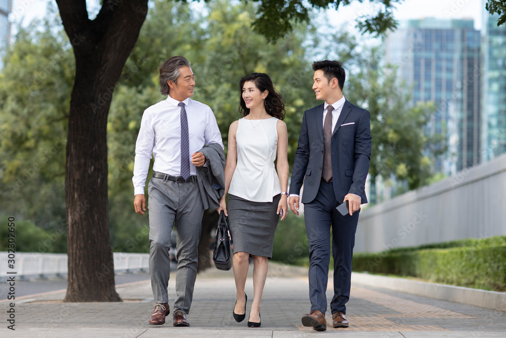 Successful Chinese business people walking on street Successful Chinese business people walking on street
