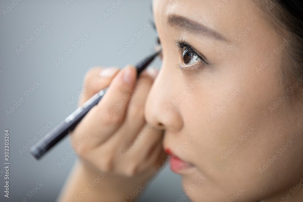 Chinese makeup artist applying makeup on model Chinese makeup artist applying makeup on model
