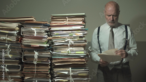 Принти на полотні Businessman checking files and piles of paperwork