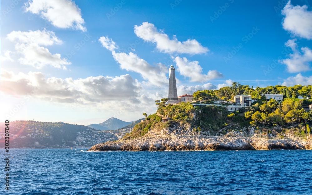 Photo Art Print View from the Mediterranean Sea of the Saint Jean Cap Ferrat lighthouse as the sun begins to set on the French Riviera in the South of France Kirk