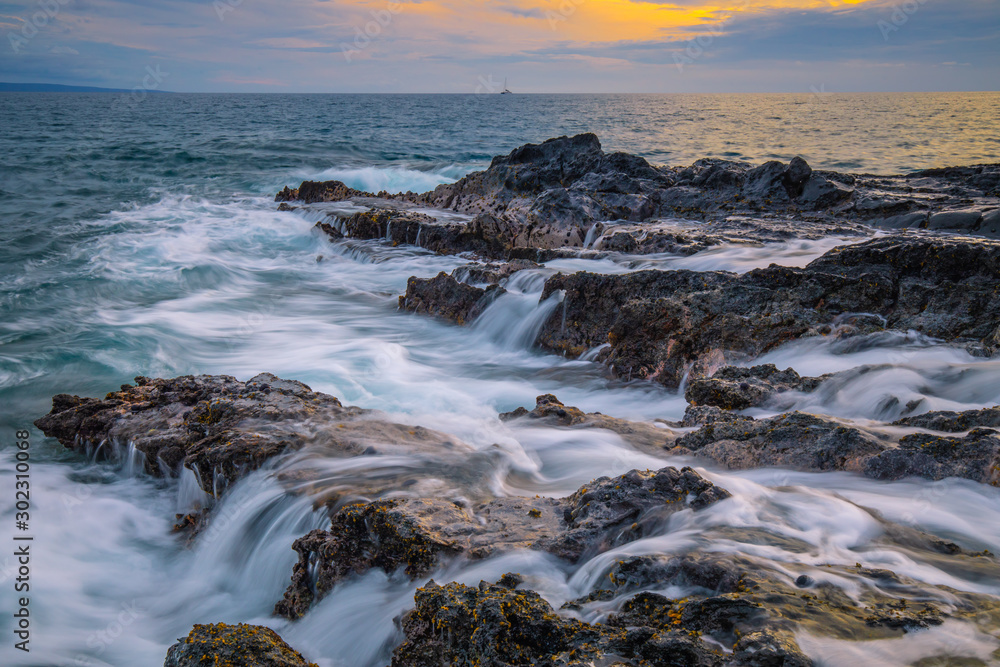 Rocky Coastline with waves at sunset from Maui