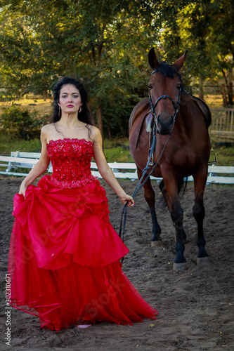 Beautiful young woman with horse outdoors