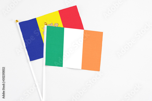 Ireland and Andorra stick flags on white background. High quality fabric, miniature national flag. Peaceful global concept.White floor for copy space. photo