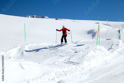 Woman-skier jumping on the hillocks