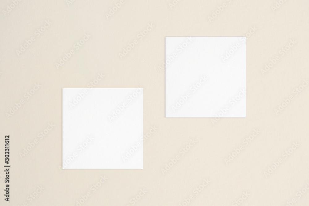 wo empty square white business cards template on bone coloured background. Flat lay, top view. Uneven, open composition. For branding identity, logo design pitches and marketing. wo empty square white business cards template on bone coloured background. Flat lay, top view. Uneven, open composition. For branding identity, logo design pitches and marketing.
