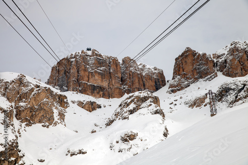 The view of Sass Pordoi cable car in winter day from lower station, Italy photo