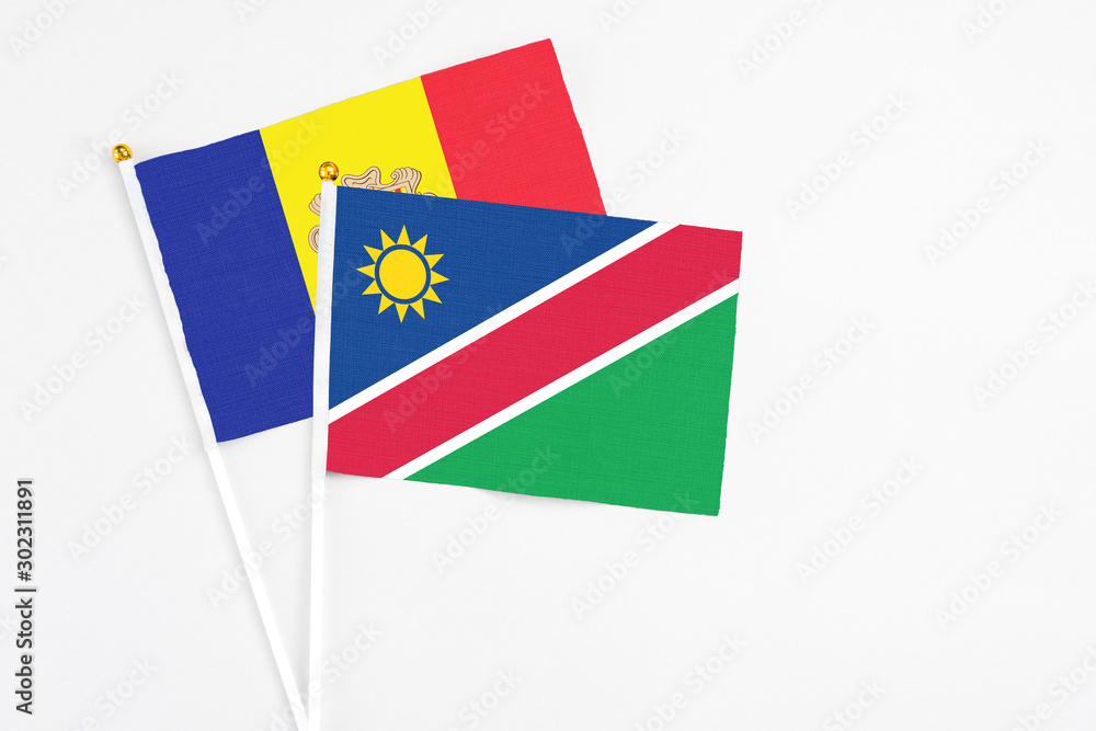 Namibia and Andorra stick flags on white background. High quality fabric, miniature national flag. Peaceful global concept.White floor for copy space.