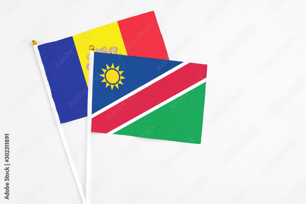 Namibia and Andorra stick flags on white background. High quality fabric, miniature national flag. Peaceful global concept.White floor for copy space. Namibia and Andorra stick flags on white background. High quality fabric, miniature national flag. Peaceful global concept.White floor for copy space.