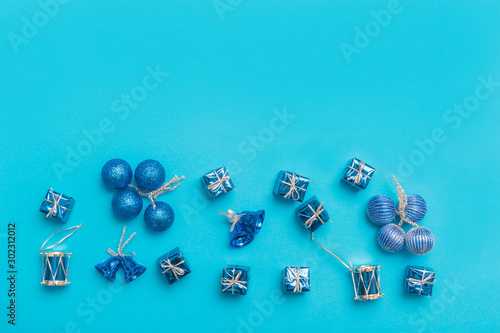 Collection of blue and turquoise miniatures with presents for christmas decoration on blue background.